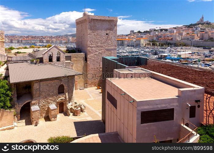View on a sunny day at the fort of St. John in the old port. Marseilles. France.. Marseilles. View of the fort of St. John and the harbor.
