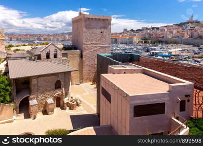View on a sunny day at the fort of St. John in the old port. Marseilles. France.. Marseilles. View of the fort of St. John and the harbor.