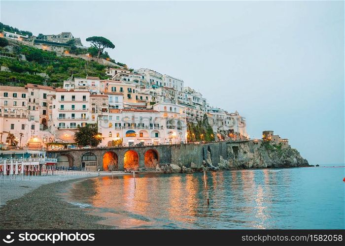 View on architecture of Amalfi town in sunset light. Amalfi is one of the most popular town in Amalfi coast in Italy. Beautiful coastal towns of Italy - scenic Amalfi village in Amalfi coast