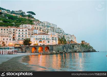 View on architecture of Amalfi town in sunset light. Amalfi is one of the most popular town in Amalfi coast in Italy. Beautiful coastal towns of Italy - scenic Amalfi village in Amalfi coast