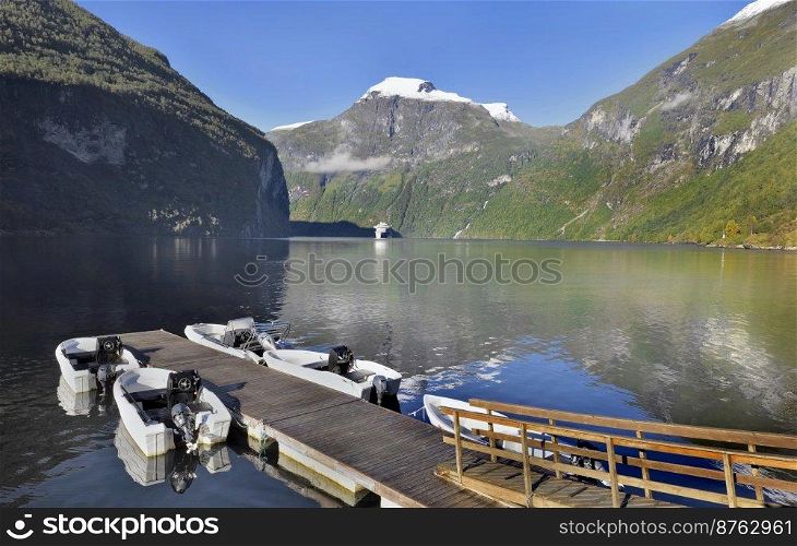 view on beautiful  geiranger fjord in Norway with pontoon and boats andtourism boat background 