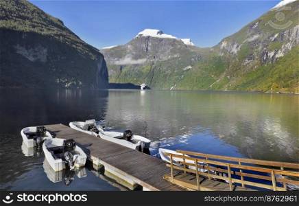 view on beautiful  geiranger fjord in Norway with pontoon and boats andtourism boat background 
