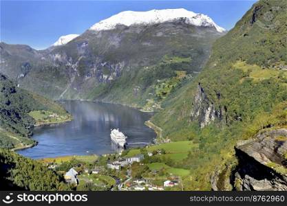 view on beautiful  geirangerfjord in Norway with the village and tourism boat 