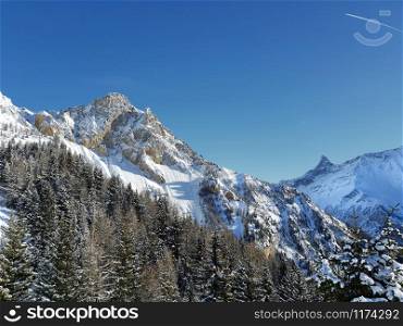 view on beautiful rocky mountain covered with snow in european Alps