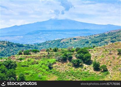 view on blue clouds under Etna craters in summer day, Sicily