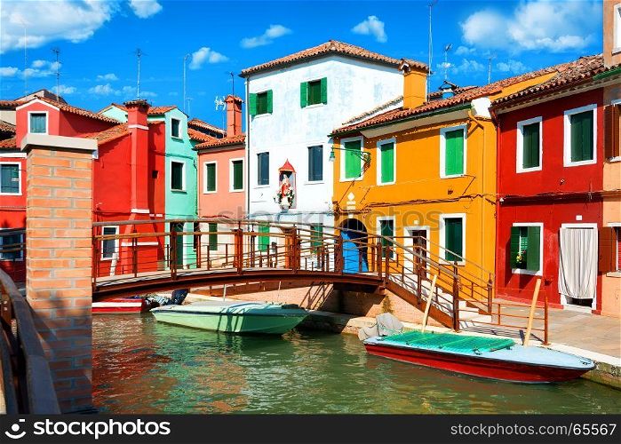 View on colored houses and water canal in the street of Burano, Italy