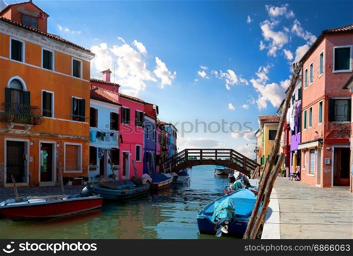View on colored houses and water canal in the street of Burano, Italy. Sunny day in Burano