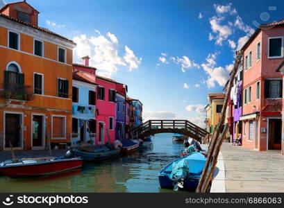 View on colored houses and water canal in the street of Burano, Italy. Sunny day in Burano