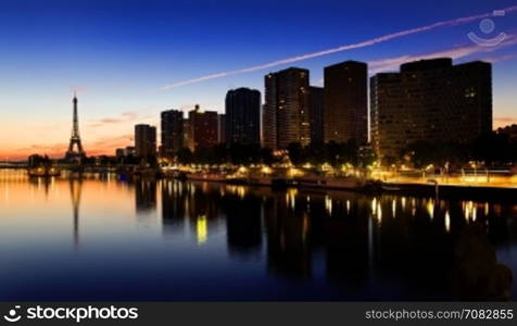 View on Eiffel tower and skyscrapers on Seine in Paris at night, France