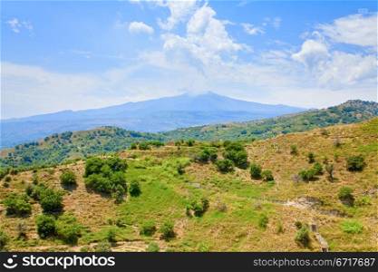 view on Etna and green sicilian hills in summer day