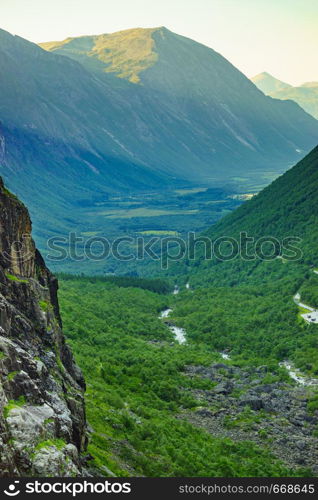 View on green summer valley fromTrollstigen mountain area in Norway Europe. National tourist route.. Green valley from Trollstigen mountain area