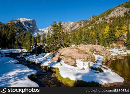 View on Hallett Peak and Flattop Mountain in snow at autumn. Trail to Emerald Lake. Rocky Mountain National Park in Colorado, USA.