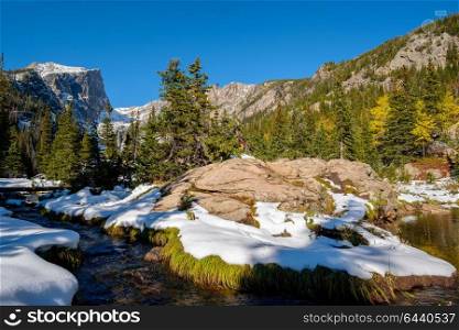 View on Hallett Peak and Flattop Mountain in snow at autumn. Trail to Emerald Lake. Rocky Mountain National Park in Colorado, USA.