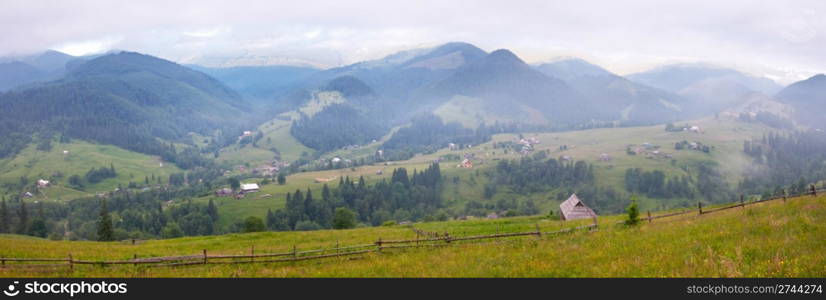 View on morning summer mountain village. Three shots stitch image.