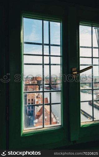 View on Old Town building in Gdansk through the window in viewing tower. Poland.. View on Old Town building in Gdansk through the window