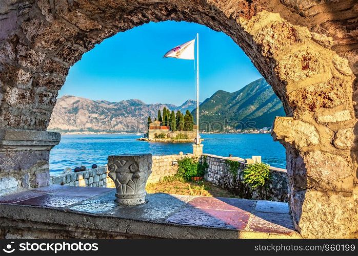 View on St George island from Our Lady of the Rocks through arch. Perast, Montenegro. St George island in arch