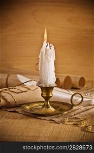view on the burning candle with old notes sheet