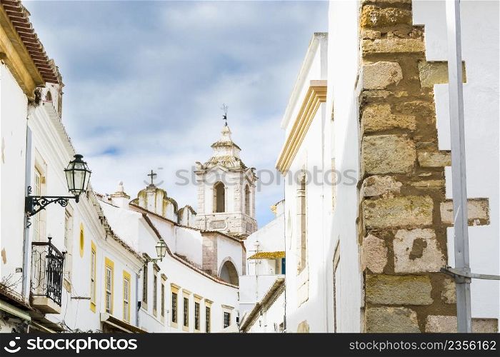 View on the narrow street with ancient buildings in medieval Portuguese city