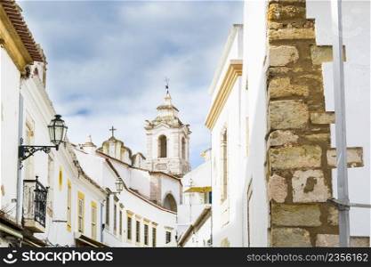 View on the narrow street with ancient buildings in medieval Portuguese city
