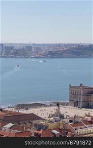 view on travel city Lisbon from top place of castle sao jorge. roofs, river tejo, brige 25 april, ships in summer day.