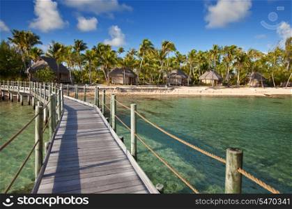 View on tropical island from the wooden bridge to the coast over the sea.