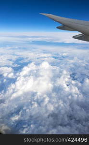 view out the window of an aircraft wing and the Brazilian landscape through clouds