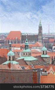 View over Nuremberg old town from the Kaiserburg, Franconia, Bavaria, Germany, with the spires of the Town Hall or Rathaus and St Lawrence church or Lorenzkirche.