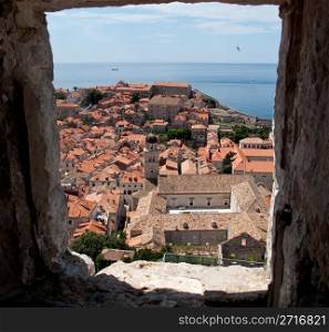 View over rooftops of Dubrovnik to tower and distant ocean