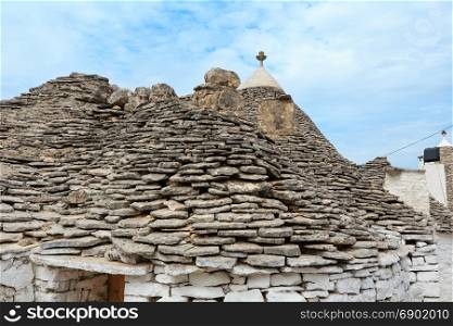 View over trulli rooftops in main touristic district of Alberobello beautiful old historic town, Apulia region, Southern Italy