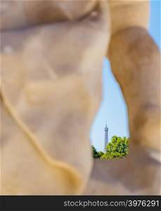 View through a staute located at the Luxembourg Gardens of the Eiffel Tower in the distance