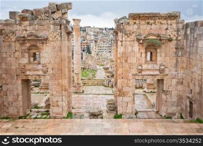 view through antique Artemis temple in ancient city Gerasa to modern Jerash , Jordan