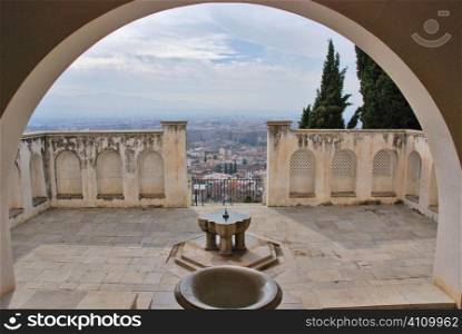 View through archway with water feature on terrace, Granada, Andalusia, Spain