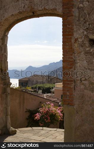 View through brick archway to typical Italian town