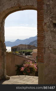 View through brick archway to typical Italian town