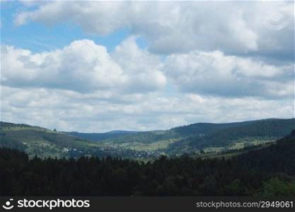 view to Carpathian mountains with forest and cloudly sky