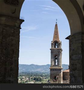 View to church San Giuliano through the Loggia by Vasari in the medieval italian city of Castiglion Fiorentino. Castiglion Fiorentino, originally an Etruscan settlement and later an old medieval village.