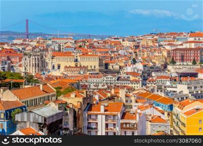 View to downtown of Lisbon with miltiple colorful houses and bridge of 25 of April over Tagys river, Portugal