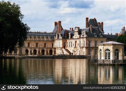 View to Fountainbleau chateau on a riverbank, France