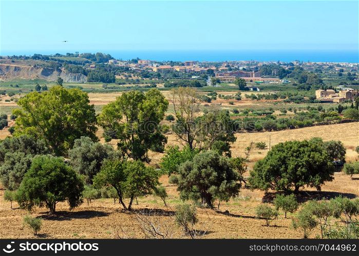 View to gardens, town and sea from famous ancient ruins in Valley of Temples, Agrigento, Sicily, Italy.