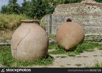View to restored inside park of castle Hisarlak with earthen vessel, near by Kyustendil town, Bulgaria