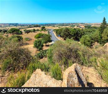 View to road, gardens and sea from Valley of Temples, Agrigento, Sicily, Italy.