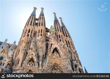 View to Sagrada Familia. BARCELONA SPAIN - May 21 2016 La Sagrada Familia - View to the facede of cathedral under bright sun, designed by Antonio Gaudi at May 21, 2016 in Barcelona, Spain.