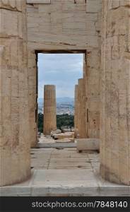 View to the city of Athens Greece from the Acropolis Propylaia. Ancient columns and gate.