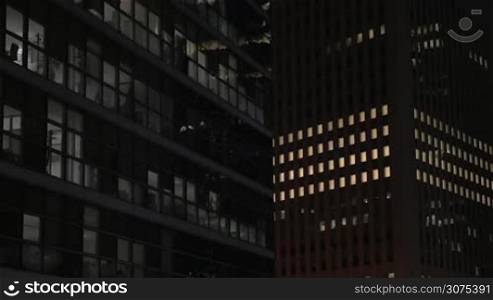 View to the skyscrapers at night. Modern office buildings with lights in the windows