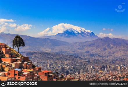 view to the snow cap of Illimani peak and valley full of living houses, El Alto, La Paz city, Bolivia