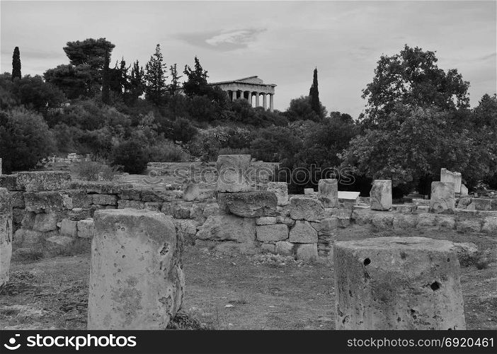 View to the temple of hephaestus from the ruins of the ancient agora in Athens, Greece. Black and white.