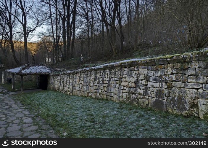 View toward inner courtyard, wall, main exit and small corner with sacred spring sourcein in Demir Baba Teke, cult monument honored by both Christians and Muslims in winter near Sveshtari village, Municipality Isperih, Razgrad District, Northeastern Bulgaria