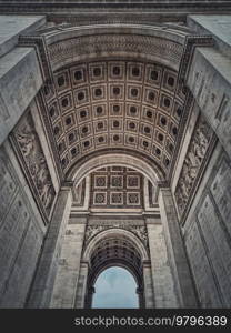 View underneath triumphal Arch  Arc de triomphe  in Paris, France. Architectural details of the famous historic landmark