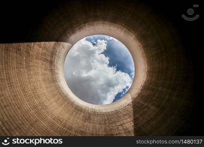 View up a coal burning power plant cooling tower on a sunny day