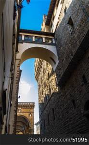 View up of a Florence street with high footbridge. Florence, Italy, Europe.
